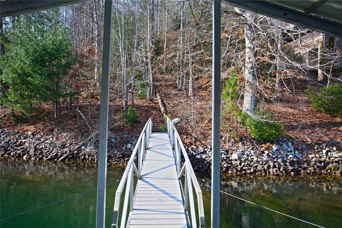 Lot 5 Royal Reserve Sunset, SC 29685 - Photo 20 of 50 A tranquil walkway leads from the waterfront to the surrounding natural landscape.