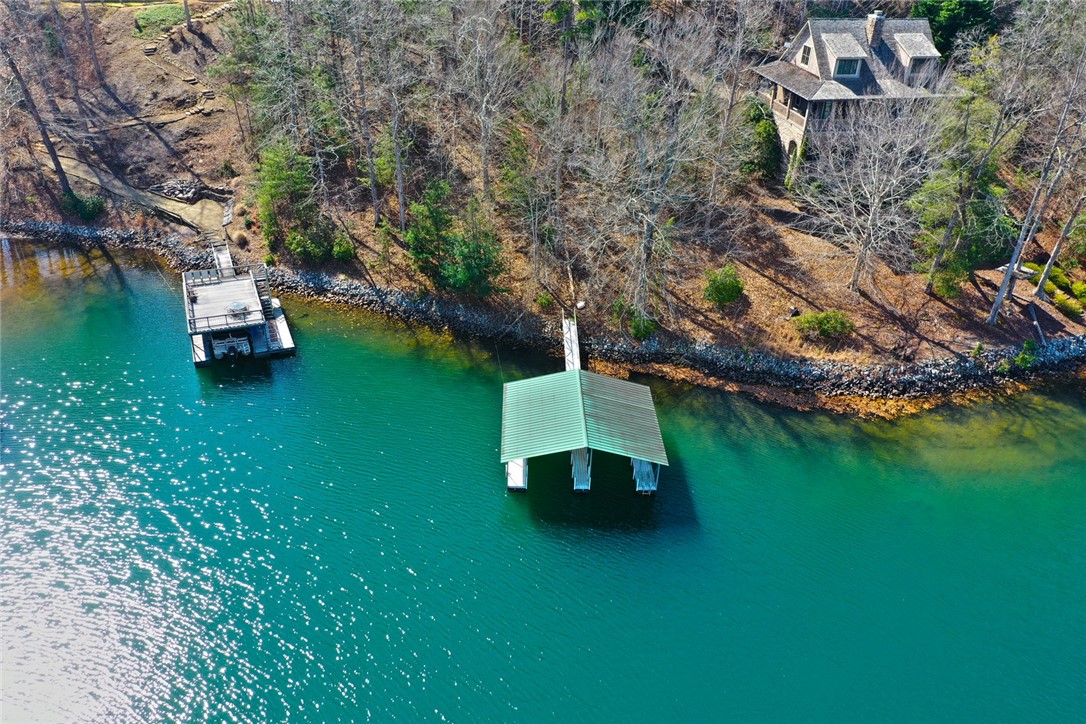Lot 5 Royal Reserve Sunset, SC 29685 - Photo 8 of 50 This tranquil lakeside property offers a private boat dock and covered boat slip, perfect for aquatic adventures.