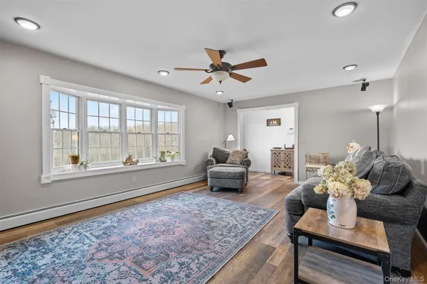 a living room with furniture and a floor to ceiling window