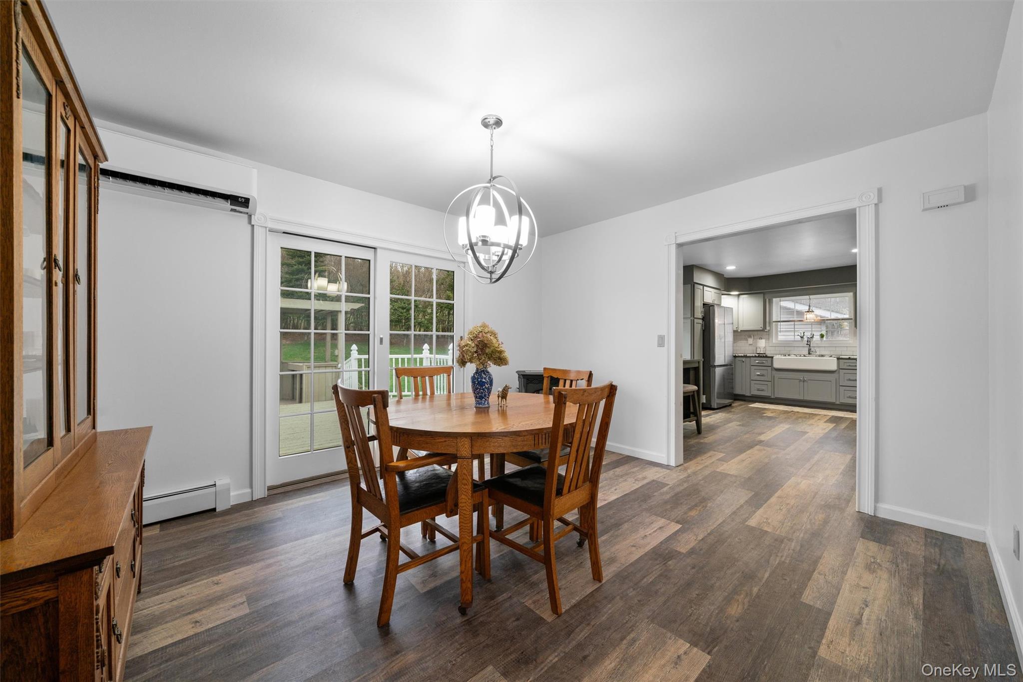5 Hess Road Callicoon, NY 12723 - Photo 13 of 45 a dining room with wooden floor a chandelier a wooden table and chairs