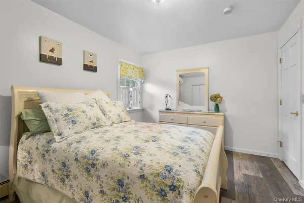 a bedroom with a bed and painting on the wall