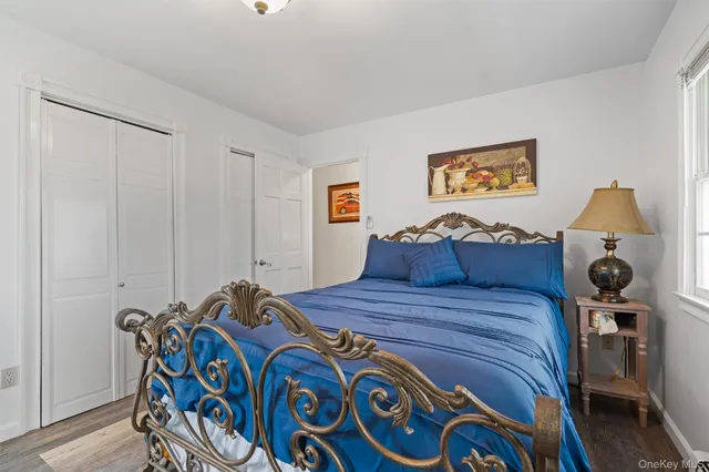 a bed room with a bed and painting on the wall