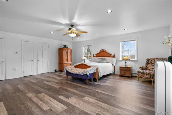 a spacious bedroom with a bed chandelier and a window