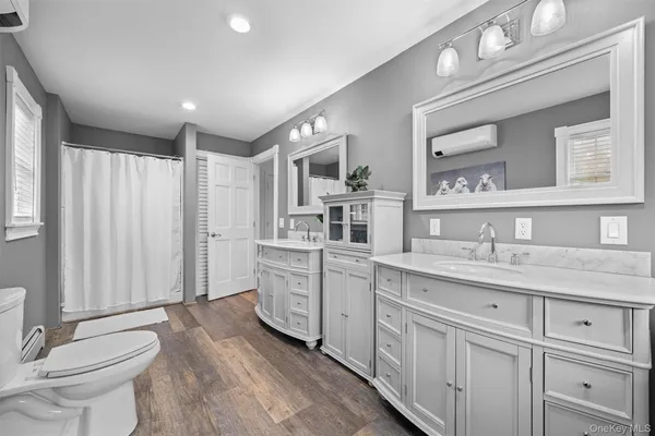 a spacious bathroom with a granite countertop sink mirror and toilet