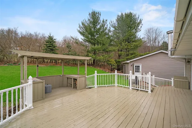 a view of a deck with a chair and floor to ceiling window