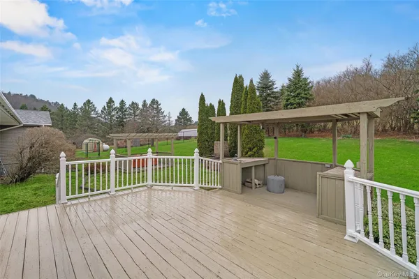 a view of a house with a wooden deck