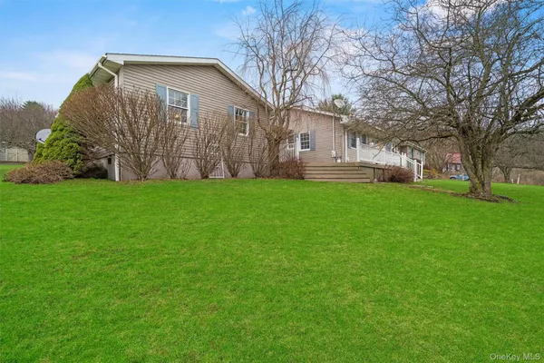 a front view of house with yard and outdoor seating