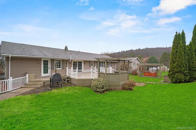 a view of a house with a yard and sitting area