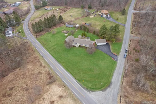 an aerial view of a house with garden space and a street view