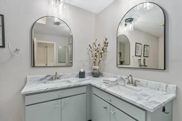 a white toilet sitting next to a bathroom sink
