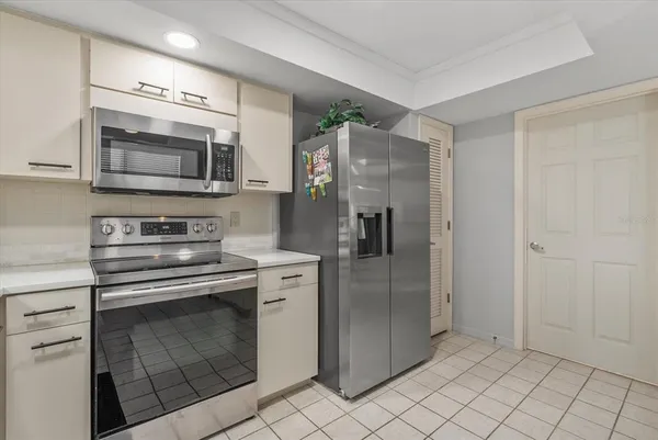 a kitchen with stainless steel appliances granite countertop a refrigerator and a stove top oven