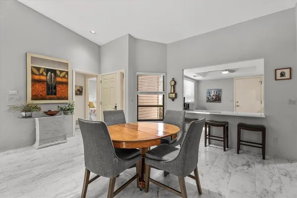 a dining room with furniture and window