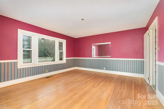 a view of empty room with window and fireplace