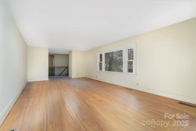 a view of empty room with fireplace