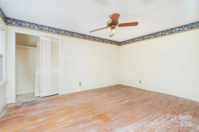 a front view of a house with a yard and potted plants