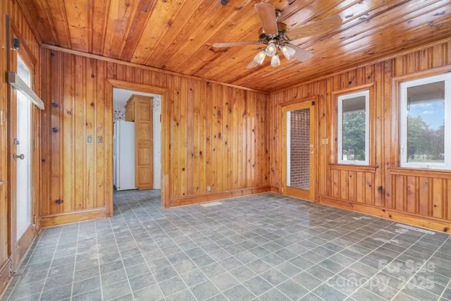 a kitchen with stainless steel appliances granite countertop a sink a stove a refrigerator a washer dryer and a dining table