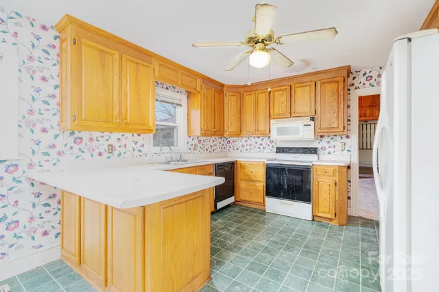 a kitchen with granite countertop a sink stainless steel appliances and cabinets