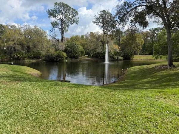 a view of a lake with a house in the background