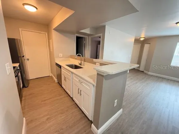 a kitchen with sink stove and refrigerator