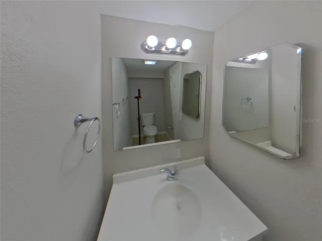 a bathroom with a sink a large mirror and shower