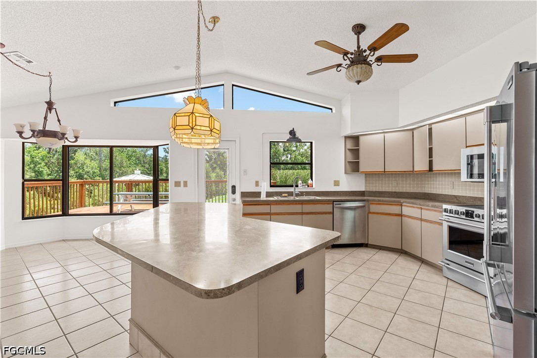 27255 Hickory Hill Road Brooksville, FL 34602 - Photo 25 of 50 a kitchen with stainless steel appliances granite countertop a sink a stove top oven a counter space and cabinets