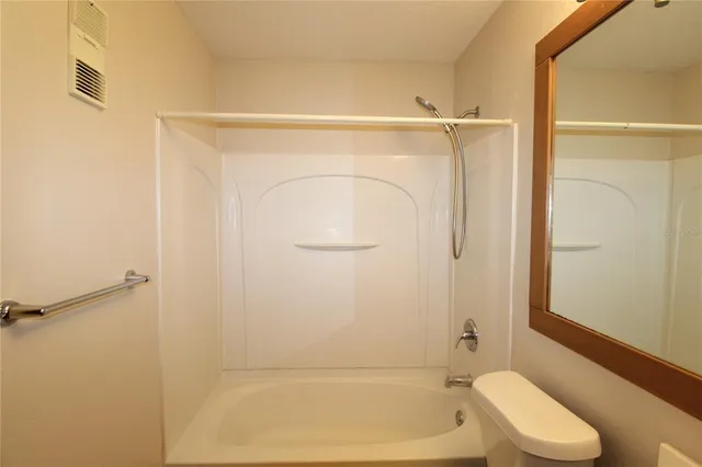 a bathroom with a shower and a toilet