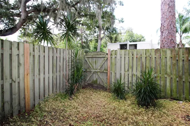 a view of a garden with wooden fence