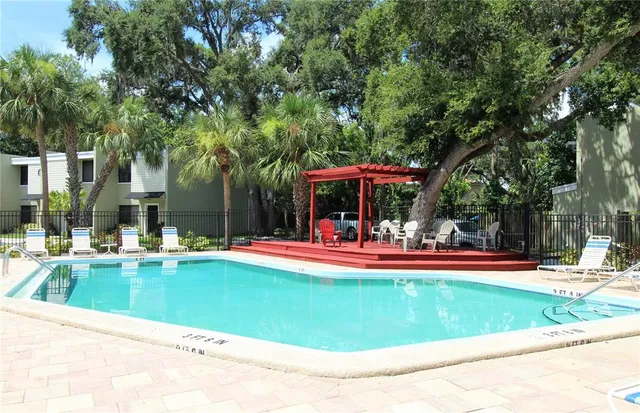 a view of a house with swimming pool and sitting area