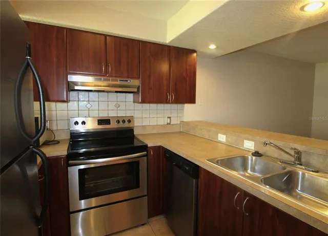 a kitchen with a sink stove and cabinets