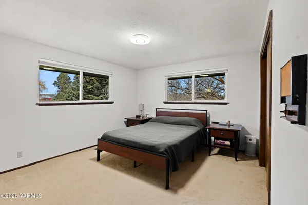 a bedroom with a bed and a painting on the wall