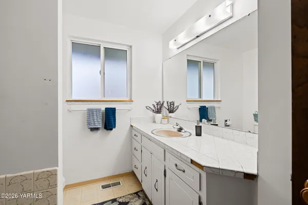a bathroom with a sink a vanity and a mirror