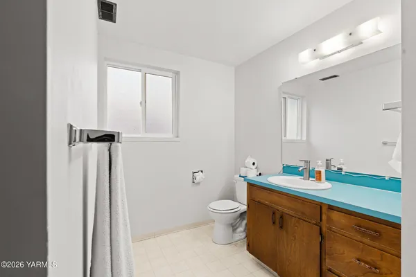 a bathroom with a sink a toilet a shower and a mirror