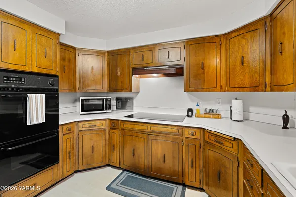 a kitchen with stainless steel appliances granite countertop a sink and cabinets