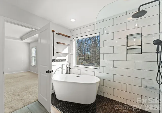 a bathroom with a bathtub and shower