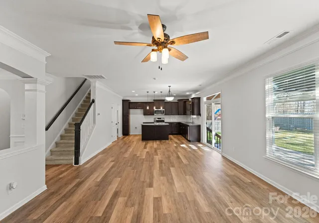 a view of a living room and kitchen with a dishwasher cabinets