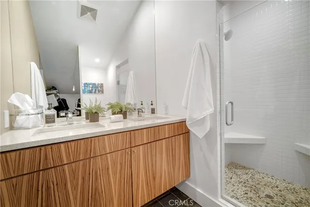a bathroom with a double vanity sink and a mirror