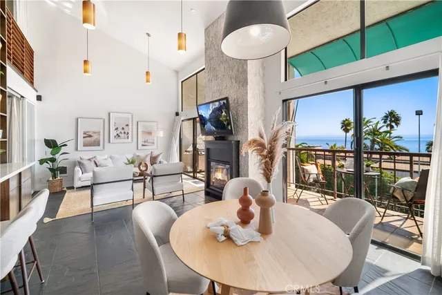 a living room with fireplace furniture and a large window
