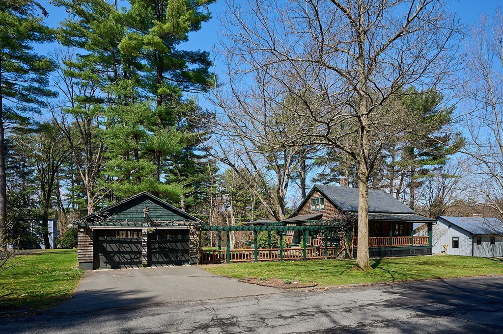27 Heatherstone Road Amherst, MA 01002 - Photo 2 of 42 a front view of a house with a garden and trees