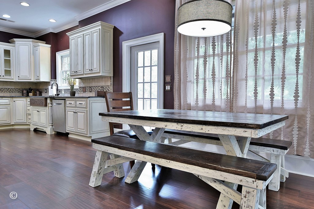 50 Grizzly Court Fortson, GA 31808 - Photo 17 of 59 a room with wooden floors table and chairs