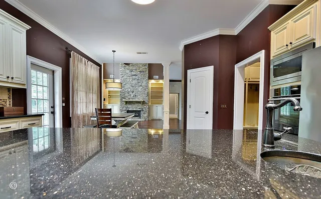 wooden floor in an empty room with a fireplace