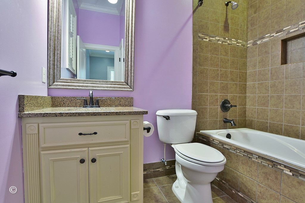50 Grizzly Court Fortson, GA 31808 - Photo 24 of 59 a bathroom with a granite countertop toilet a sink and a mirror