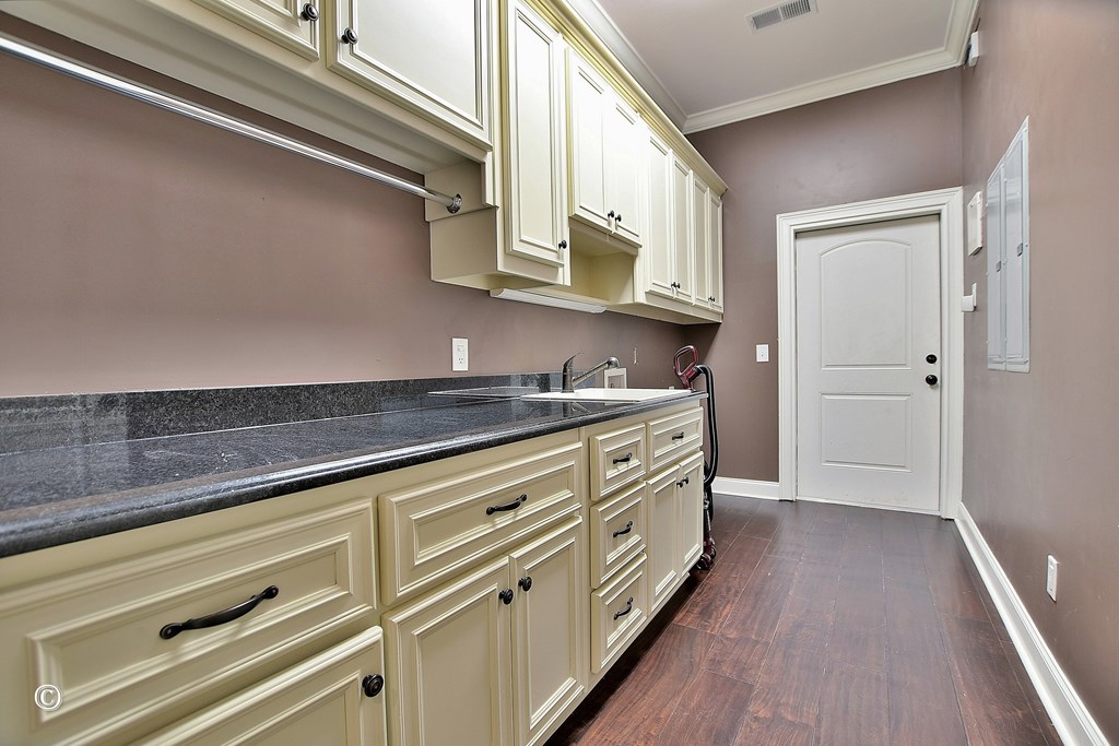 50 Grizzly Court Fortson, GA 31808 - Photo 26 of 59 a kitchen with granite countertop white cabinets and white appliances