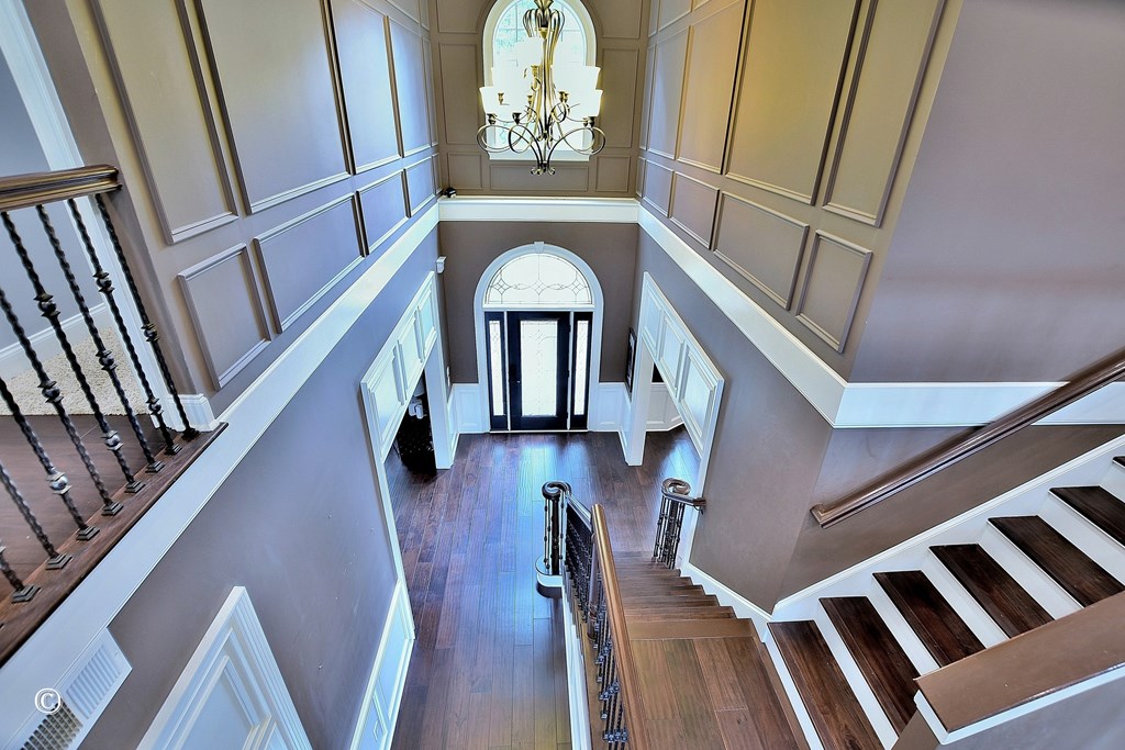 50 Grizzly Court Fortson, GA 31808 - Photo 28 of 59 a view of staircase with lots of frames on wall and wooden floor