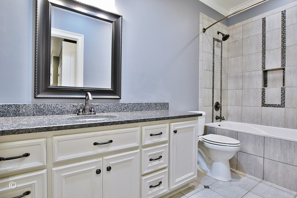 50 Grizzly Court Fortson, GA 31808 - Photo 38 of 59 a bathroom with a granite countertop sink toilet mirror and a shower
