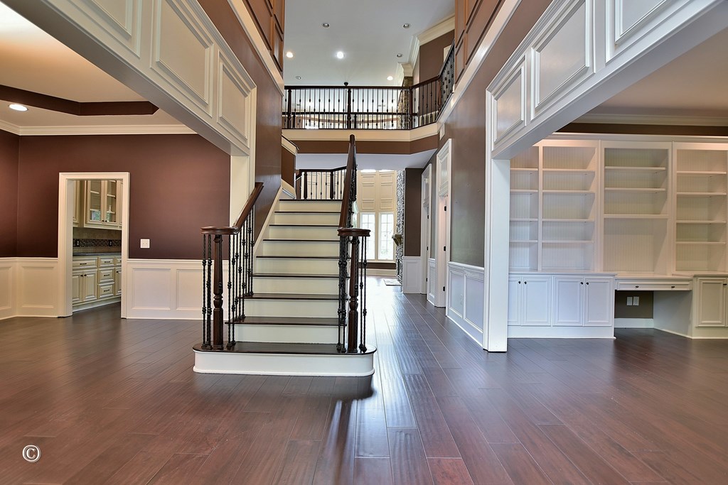 50 Grizzly Court Fortson, GA 31808 - Photo 6 of 59 a view of a hallway with wooden floor and staircase