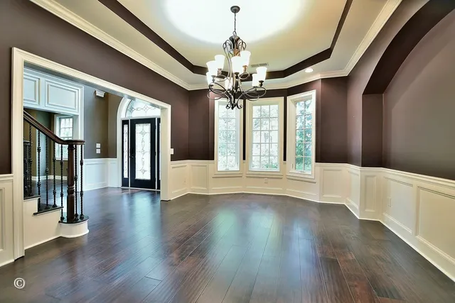 a kitchen with stainless steel appliances granite countertop a table chairs stove microwave and cabinets