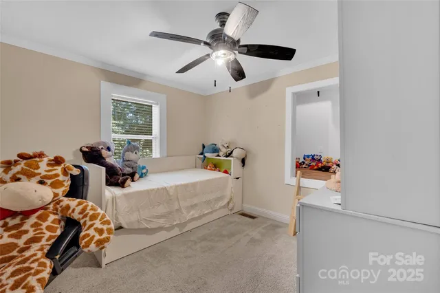 a bedroom with furniture and a chandelier fan