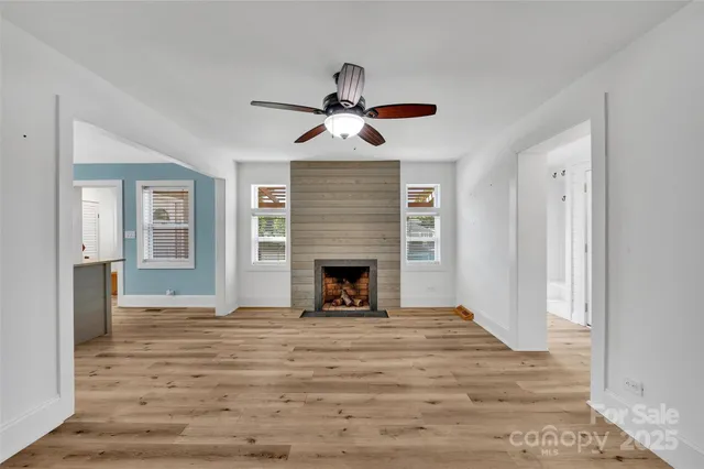 a view of a livingroom with a fireplace and window