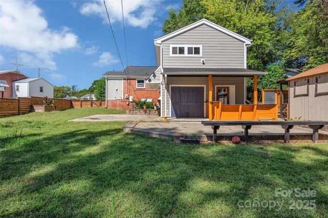 a front view of a house with swing and a fence