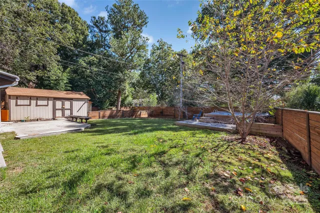a view of a house with backyard sitting area and garden